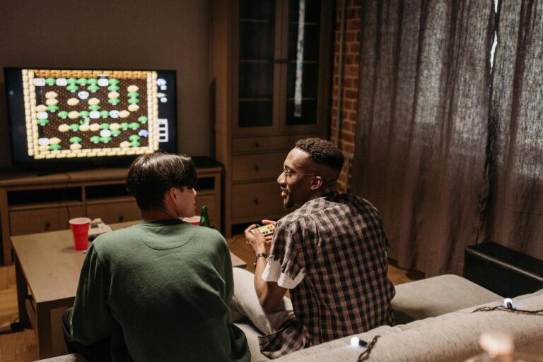 Two friends playing video games together in a cozy living room setting.